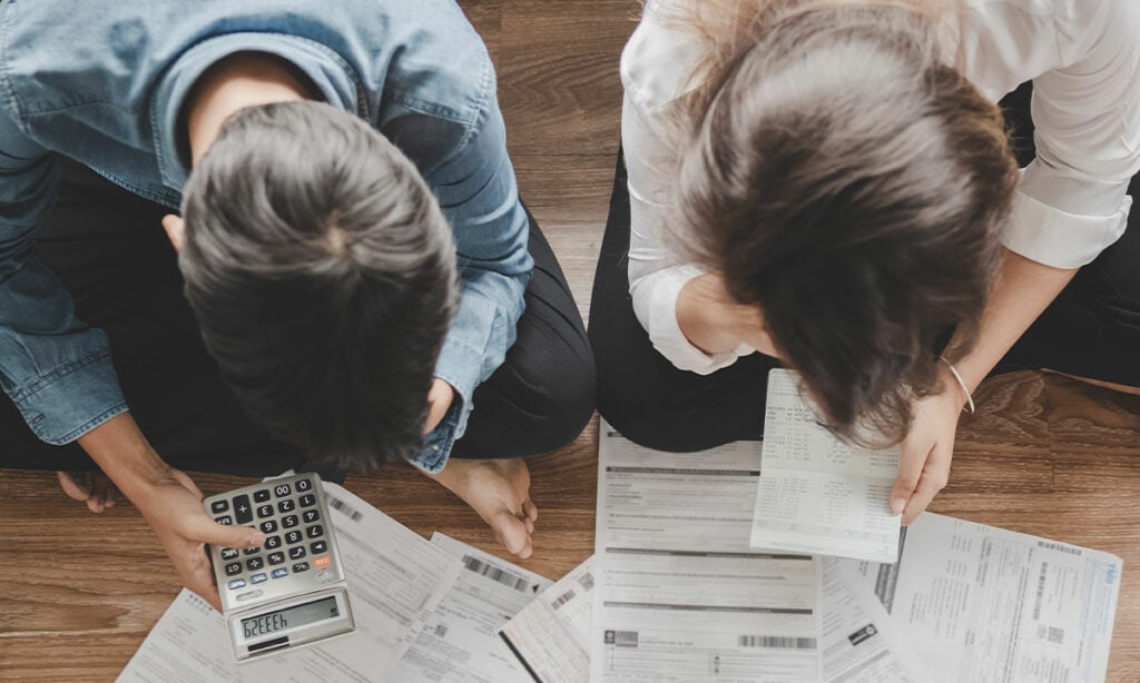 couple looking over bills in need of Unsecured Personal Loans NZ