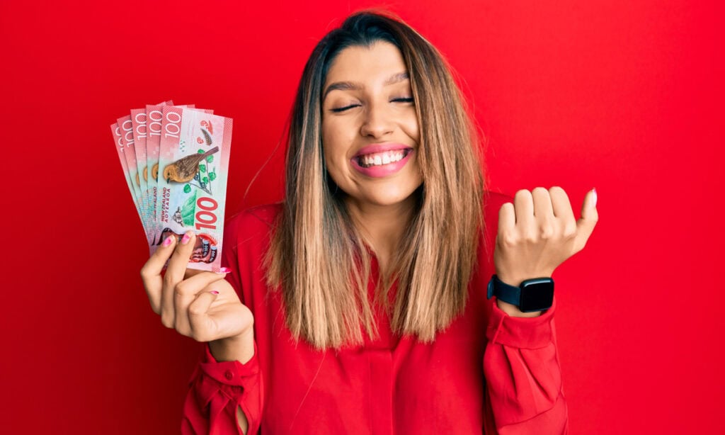 woman holding cash with a smile because she has gotten a loan for fair credit