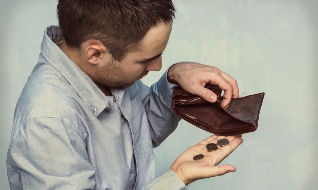 man looking in wallet with no cash needing an instant cash loan